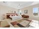 Bright main bedroom with a king-size bed and sitting area at 871 Iron Oak Way, The Villages, FL 32163