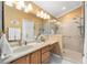 Bright bathroom featuring a large vanity and a walk-in shower at 8457 Se 177Th Penman Pl, The Villages, FL 32162