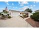 Single-story home with a two-car garage and landscaped yard at 8457 Se 177Th Penman Pl, The Villages, FL 32162