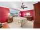 Relaxing bedroom with floral bedding and ceiling fan at 8457 Se 177Th Penman Pl, The Villages, FL 32162