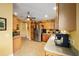 Inviting kitchen featuring stainless steel appliances and wood cabinetry at 8457 Se 177Th Penman Pl, The Villages, FL 32162