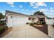 Front view of a house featuring a screened garage and fountain at 8457 Se 177Th Penman Pl, The Villages, FL 32162