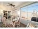 Sunroom features a glass table, chairs, and view into kitchen at 8457 Se 177Th Penman Pl, The Villages, FL 32162