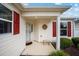 Inviting front porch with a wreath and a stone bench at 8457 Se 177Th Penman Pl, The Villages, FL 32162