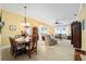 Formal dining room with a wooden table and chandelier at 8457 Se 177Th Penman Pl, The Villages, FL 32162