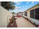 Relaxing backyard with red hanging patio swing at 8457 Se 177Th Penman Pl, The Villages, FL 32162