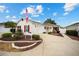Single-story home with a two-car garage and landscaped yard at 8457 Se 177Th Penman Pl, The Villages, FL 32162