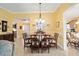Bright dining room with a large table and view of kitchen at 8457 Se 177Th Penman Pl, The Villages, FL 32162