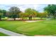 Golf course putting green surrounded by trees at 44 Camino Real Blvd # 44, Howey In The Hills, FL 34737