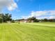 Aerial view of a single-Gathering home with expansive lawn and detached garage at 275 Cr 552, Bushnell, FL 33513