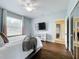 Bright bedroom with a ceiling fan, large window, and dark hardwood floors at 275 Cr 552, Bushnell, FL 33513