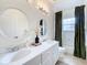 Elegant bathroom with double vanity, large mirrors, and a relaxing tub at 275 Cr 552, Bushnell, FL 33513