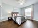 Bedroom with hardwood floors, a ceiling fan, and large window with curtains at 275 Cr 552, Bushnell, FL 33513