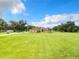 Single-story home with large yard, showcasing a light beige exterior at 275 Cr 552, Bushnell, FL 33513