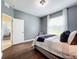 Bright bedroom with wood flooring, large window, and plush bedding at 275 Cr 552, Bushnell, FL 33513