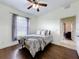 Well-lit bedroom with ceiling fan, wood floors, and window at 275 Cr 552, Bushnell, FL 33513