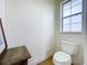 Small bathroom with a toilet and a single window at 275 Cr 552, Bushnell, FL 33513