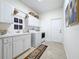 Bright laundry room with washer, dryer, cabinets, and extra storage at 275 Cr 552, Bushnell, FL 33513