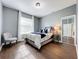Comfortable bedroom with wood floors and a window with blinds at 275 Cr 552, Bushnell, FL 33513