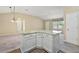 Kitchen island with granite countertop and white cabinets at 1268 Camero Dr, The Villages, FL 32159