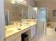 Double vanity bathroom with a large soaking tub, shower, and ample counter space at 2277 Calvert Ct, Clermont, FL 34711