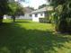 Large backyard with lush green grass and mature trees at 2277 Calvert Ct, Clermont, FL 34711