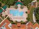 Top-down view of a community pool with surrounding patio and building at 2277 Calvert Ct, Clermont, FL 34711
