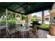 Covered patio area with grill and seating at 2277 Calvert Ct, Clermont, FL 34711