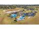 Aerial view of community pool with multiple pools, landscaping, and ample parking at 2277 Calvert Ct, Clermont, FL 34711