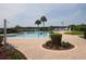 Inviting community pool with brick patio and lush landscaping at 2277 Calvert Ct, Clermont, FL 34711