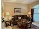 Cozy living room with a brown sofa and end tables at 2277 Calvert Ct, Clermont, FL 34711