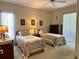 Guest bedroom with two twin beds, window with curtains, and a ceiling fan at 2277 Calvert Ct, Clermont, FL 34711