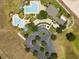 Aerial view showing community pool, clubhouse, and parking areas at 2277 Calvert Ct, Clermont, FL 34711