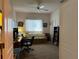 Home office with built-in shelving, a comfortable couch, and plenty of natural light at 2277 Calvert Ct, Clermont, FL 34711