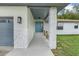 Front entrance with gray door and stone accents at 10822 E Revels Rd, Howey In The Hills, FL 34737