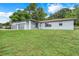 House exterior featuring gray accents and a large yard at 10822 E Revels Rd, Howey In The Hills, FL 34737