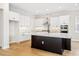 Modern kitchen with white cabinets and a large island at 15607 Vetta Dr, Montverde, FL 34756