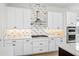Modern kitchen with white cabinets, stainless steel appliances, and quartz countertops at 15607 Vetta Dr, Montverde, FL 34756