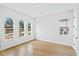 Spacious bedroom with hardwood floors and arched windows at 15607 Vetta Dr, Montverde, FL 34756