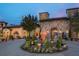 Tuscan-style community entrance with fountain and landscaping at 15607 Vetta Dr, Montverde, FL 34756