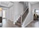 Modern staircase with wood treads and metal balusters in a light-filled hallway at 15644 Vetta Dr, Montverde, FL 34756