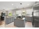 Spacious kitchen with island, stainless steel appliances, and gray cabinets at 2115 Oak Leaf Cir, Mount Dora, FL 32757