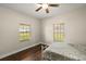 Cozy bedroom with wood floors and two windows at 2115 Oak Leaf Cir, Mount Dora, FL 32757