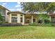 Home with covered patio, lush landscaping and golf course view at 9323 San Jose Blvd, Howey In The Hills, FL 34737
