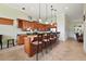 Modern kitchen with granite counters, wood cabinets, and an island with seating at 9323 San Jose Blvd, Howey In The Hills, FL 34737