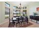 Elegant dining room with dark wood table and chairs, overlooking a golf course at 9323 San Jose Blvd, Howey In The Hills, FL 34737