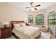 Bedroom with a queen bed, ceiling fan, and bay window at 9323 San Jose Blvd, Howey In The Hills, FL 34737