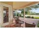 Covered patio with brick flooring and wicker furniture at 9323 San Jose Blvd, Howey In The Hills, FL 34737
