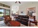 Open living space with leather furniture, views to the kitchen and a private office at 9323 San Jose Blvd, Howey In The Hills, FL 34737