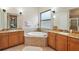 Spacious bathroom with double vanity, soaking tub, and separate shower at 9323 San Jose Blvd, Howey In The Hills, FL 34737